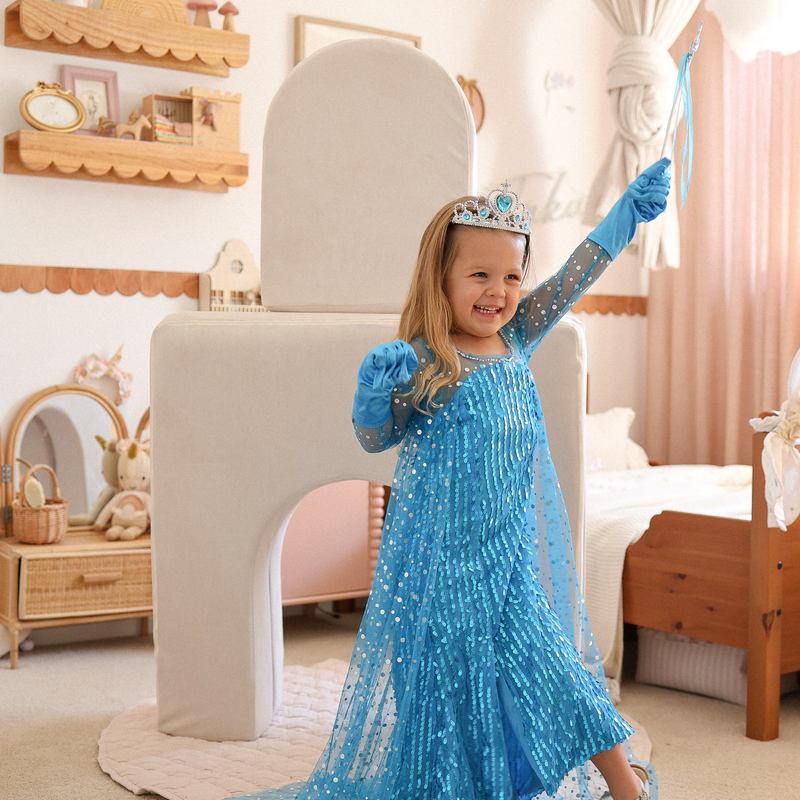 Possum Play Tunnels & Shields in Babycino — girl in a princess dress raising her wand beside a foam arch shield