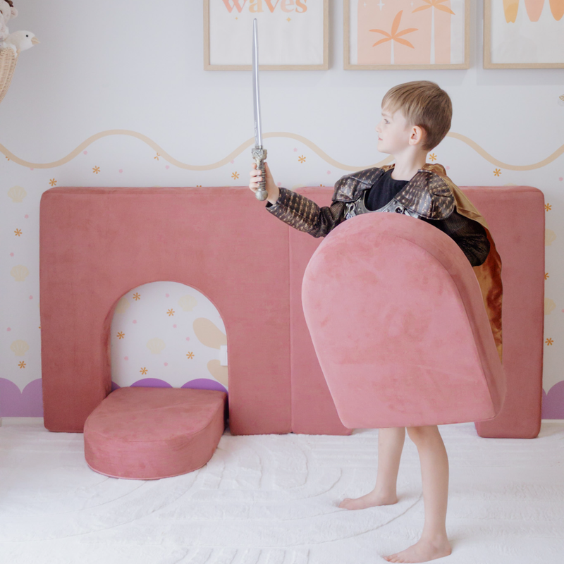 Possum Play Tunnels & Shields in Hibiscus — boy in a knight costume using the foam arch cushion as a shield