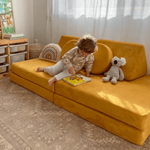 Toddler child reading book on Possum Play Couch in Sunshine Yellow - quiet time play